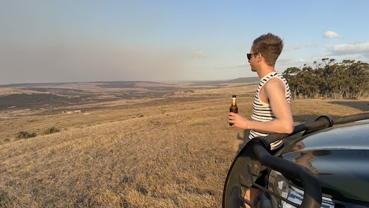 Joe having a drink while out on Safari